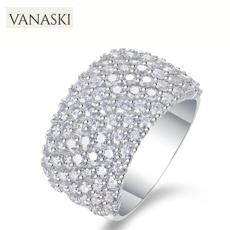 Silver ring with clear stones on a white background, featuring the Vanaski brand.