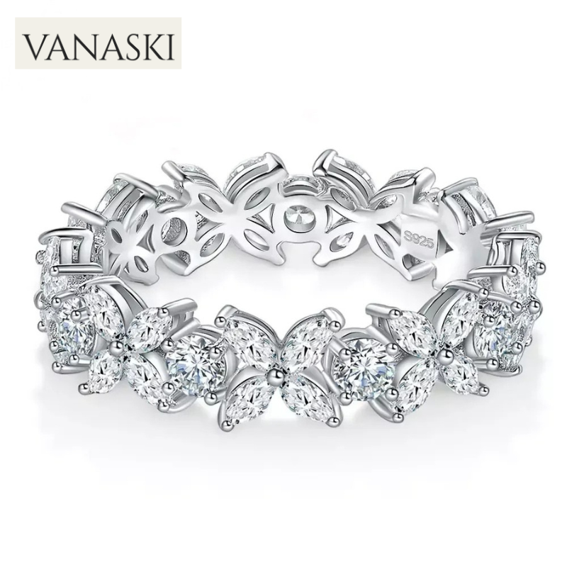Silver ring with butterfly designs and diamonds on a white background, featuring the Vanaski brand.