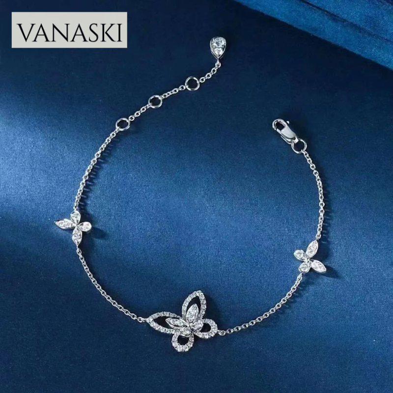 Silver bracelet with butterfly designs on a blue background, featuring the Vanaski brand.