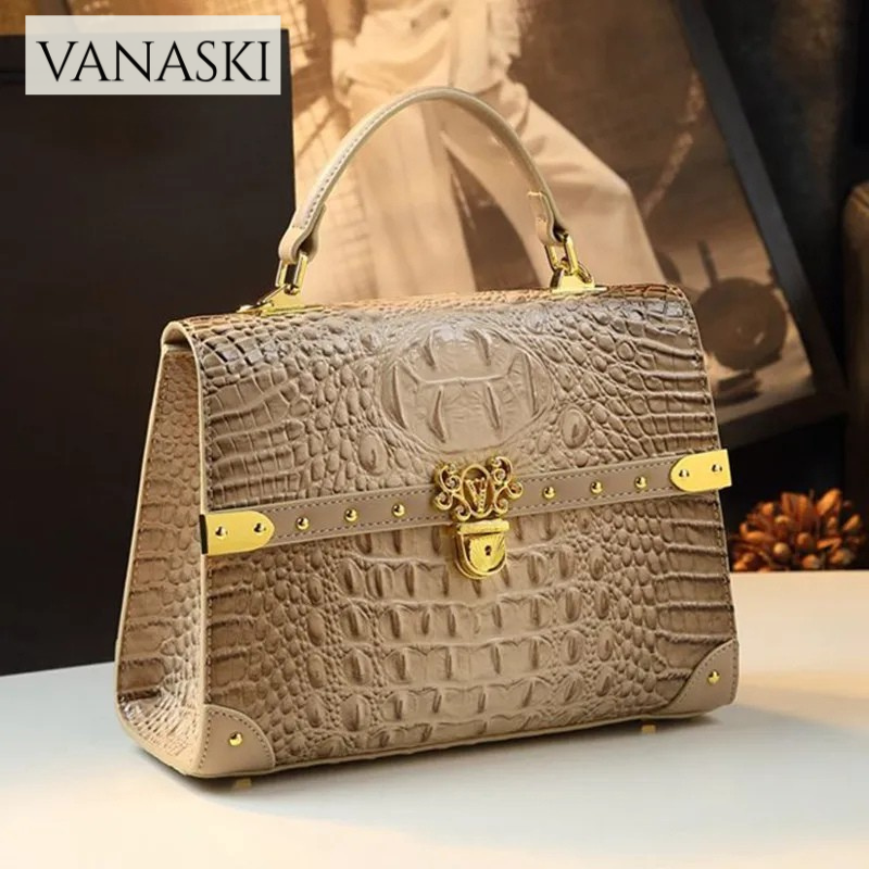 Beige handbag with gold accents on a light surface, featuring the Vanaski brand.