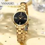 Gold wristwatch with black dial on a sparkling background, featuring the brand 'VANASKI'.