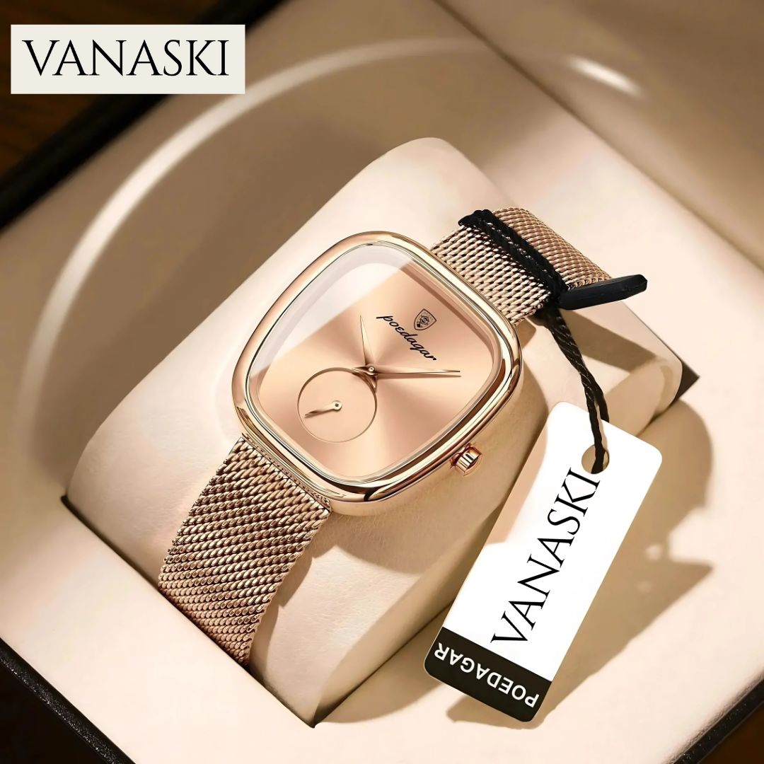 Gold watch with mesh band and 'VANASKI' tag on a beige background