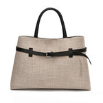 Beige handbag with black strap and handle on a white background