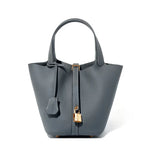 Gray handbag with a gold lock on a white background
