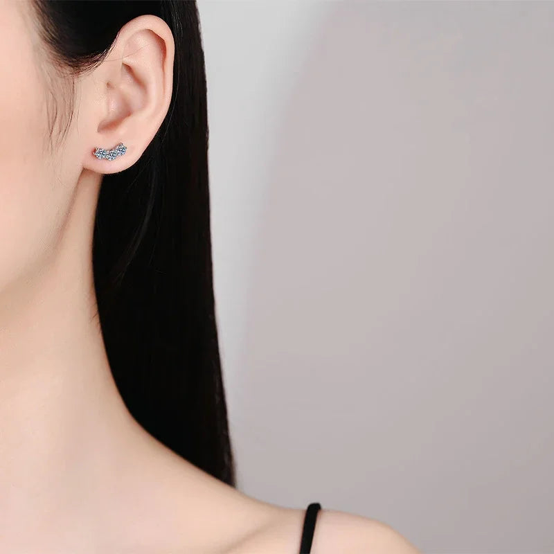 Close-up of an ear wearing a small earring with a blurred background