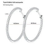 Silver hoop earrings with moissanite stones, showing dimensions and material details.