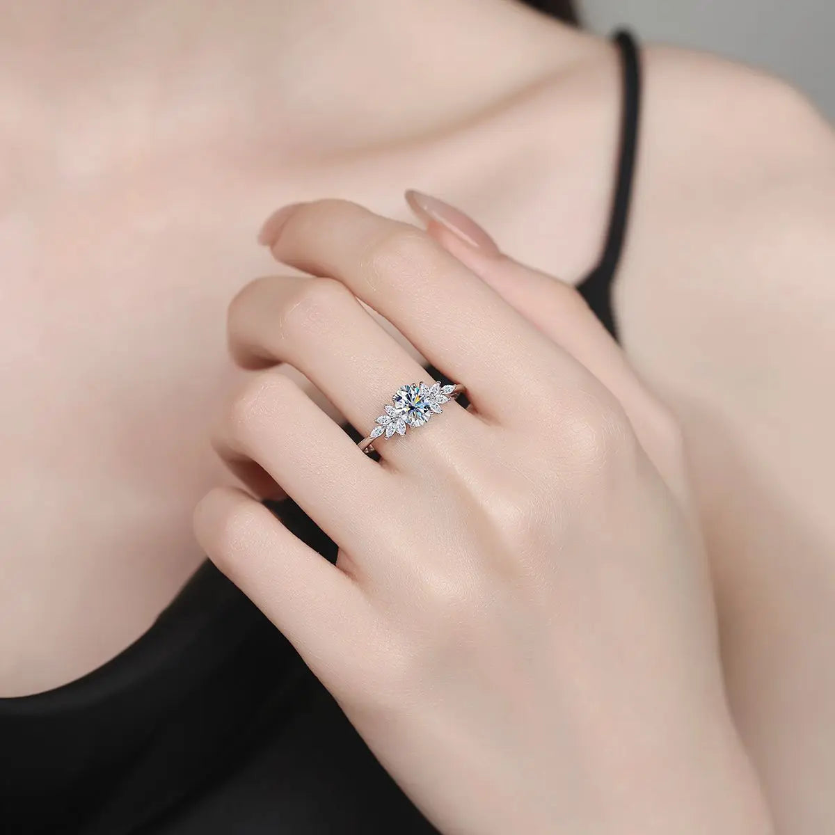 Close-up of a hand wearing a diamond ring with a blurred background