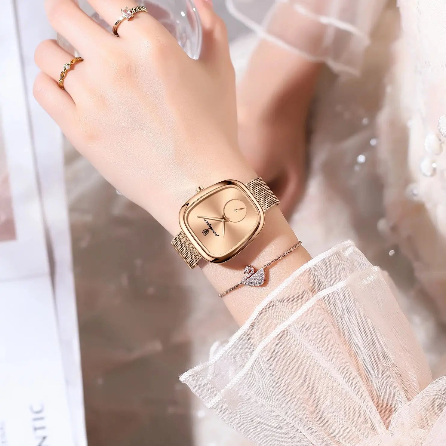 Gold wristwatch on a wrist with a soft, blurred background
