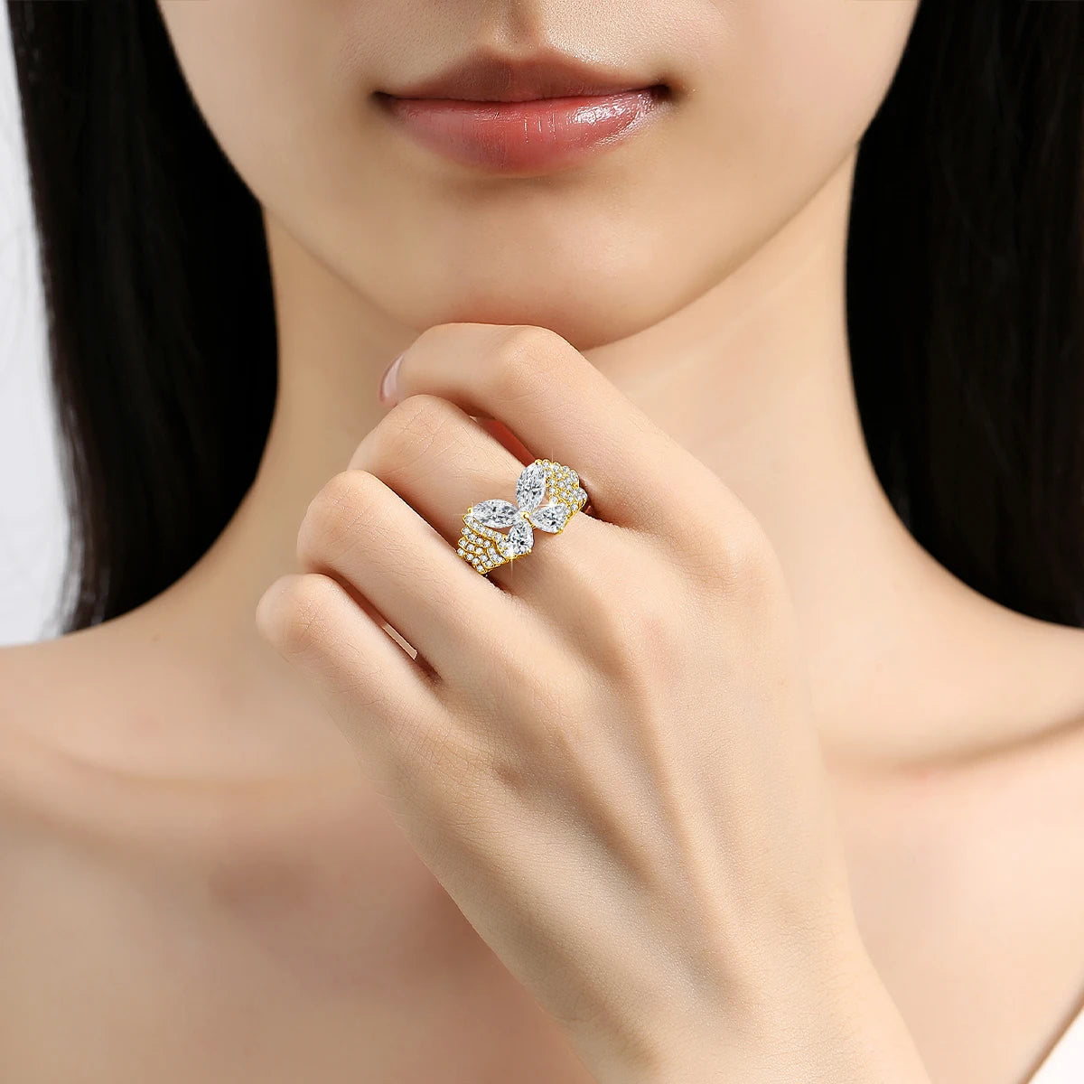 Close-up of a woman's hand wearing a gold and diamond ring.