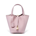 Pink handbag with a gold clasp on a white background