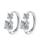 Silver hoop earrings with clear gemstones on a white background