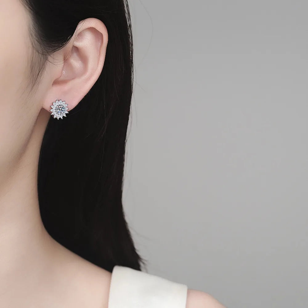 Close-up of a person wearing a diamond earring on a plain background
