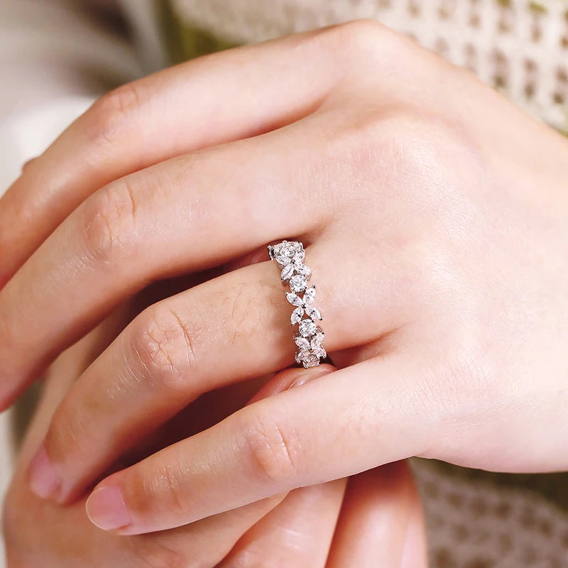 Close-up of a hand wearing a diamond ring with a blurred background