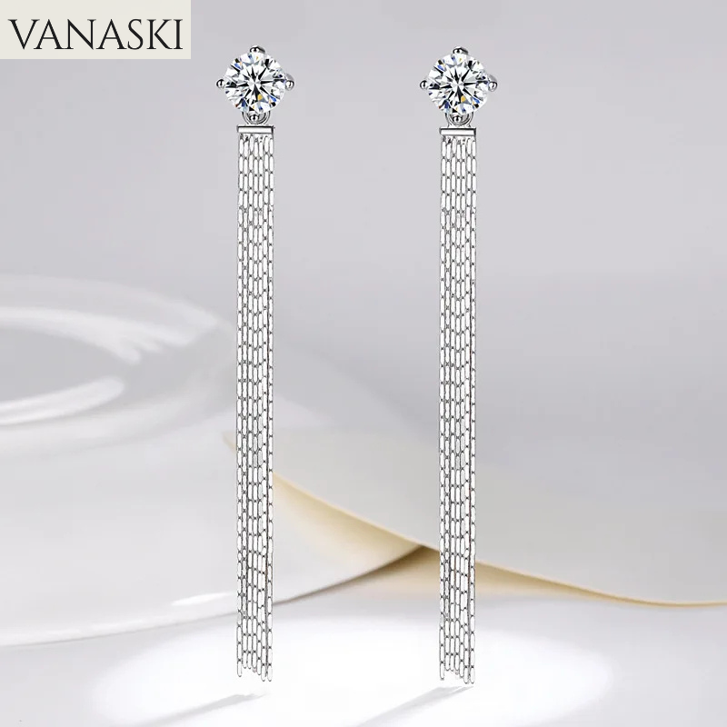 Silver tassel earrings with floral tops on a white background, branded 'VANASKI'.