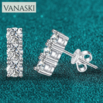 Silver stud earrings with clear gemstones on a teal background, featuring the Vanaski brand.