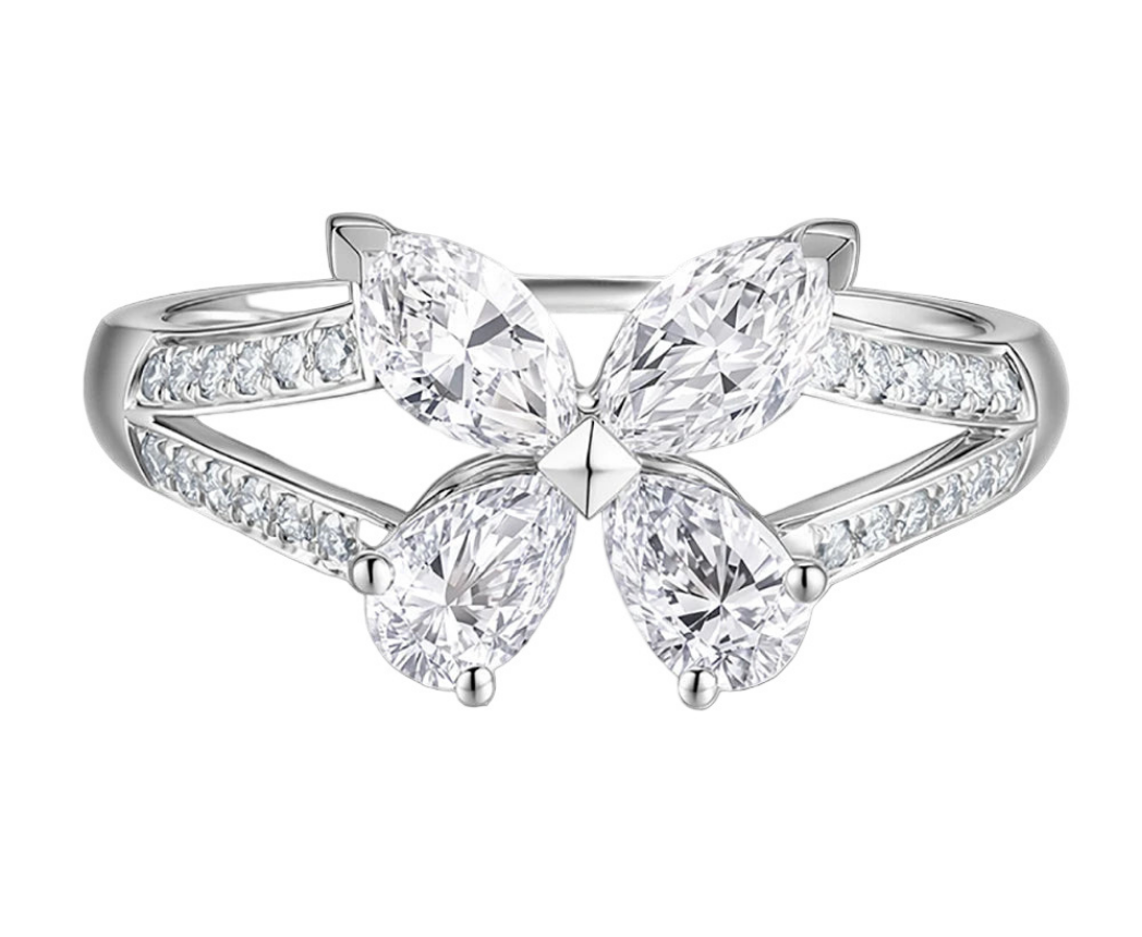 Diamond ring with three pear-shaped diamonds on a white background