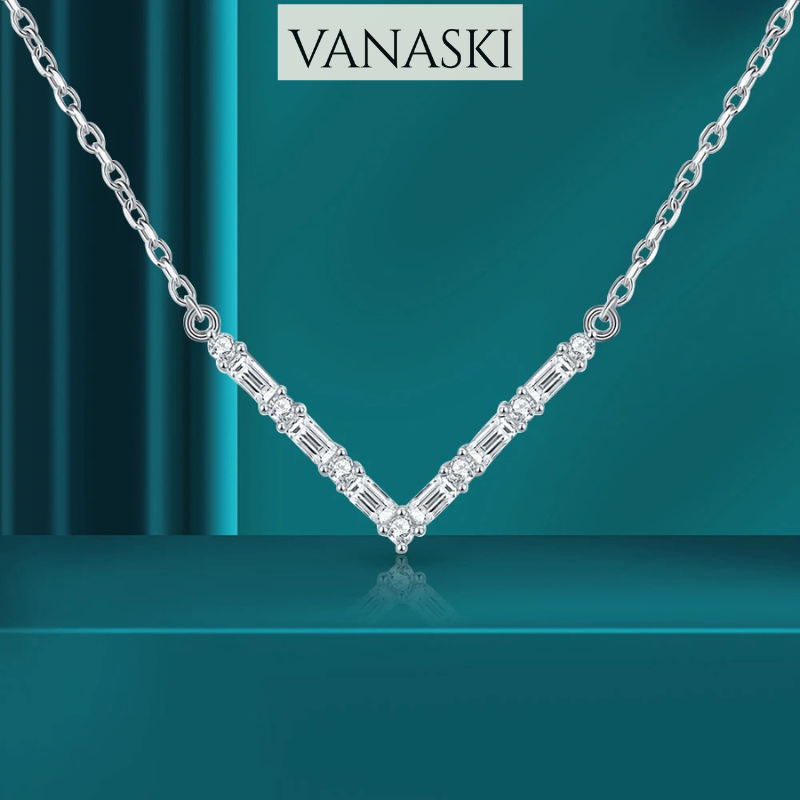 Silver necklace with diamonds on a teal background, featuring the Vanaski brand.
