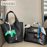 Two black handbags with unique decorative elements on a neutral background, featuring the Vanaski brand.