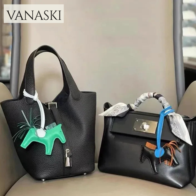 Two black handbags with unique decorative elements on a neutral background, featuring the Vanaski brand.