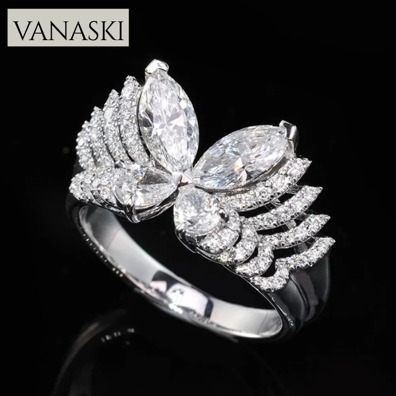 Silver ring with diamond-like stones on a black background, featuring the Vanaski brand.