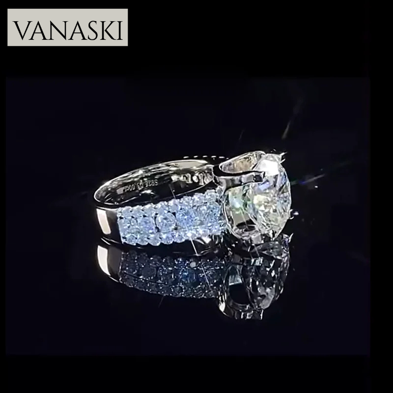Vanaski diamond ring with a large central gemstone and smaller ones on a black background