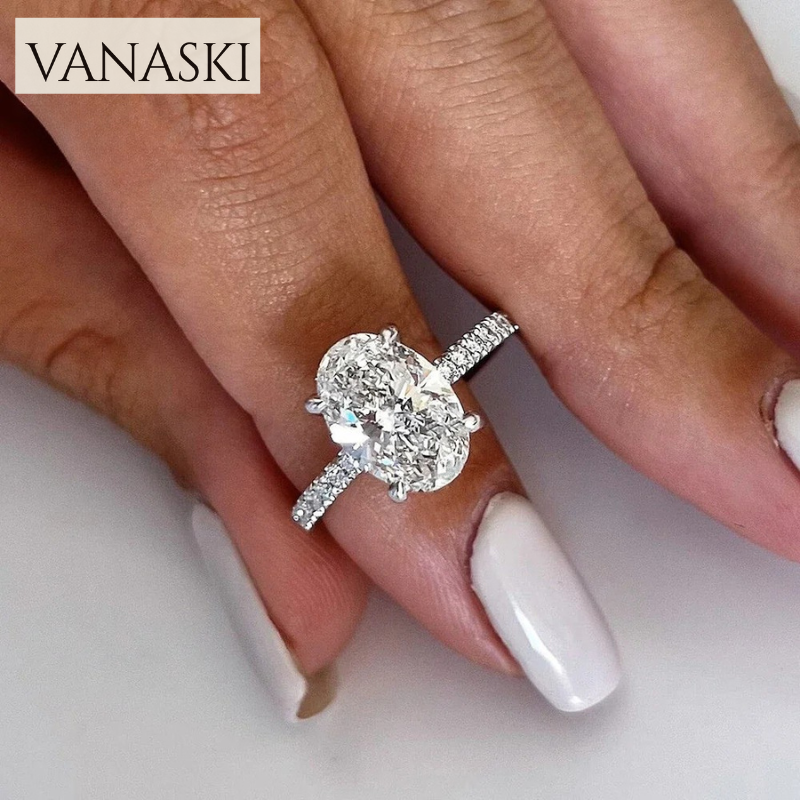 Diamond ring on a finger with 'VANASKI' branding