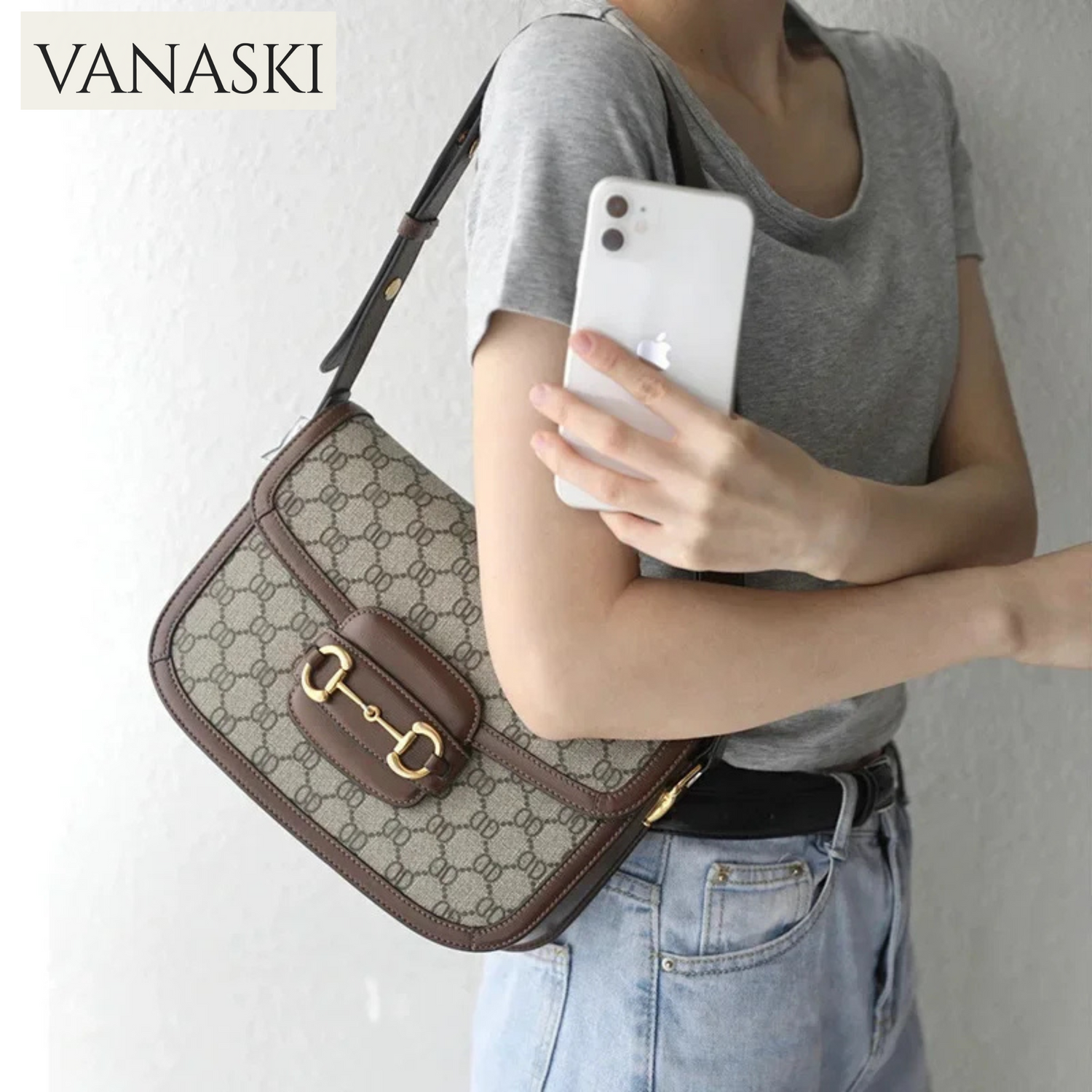 Person holding a Vanaski handbag with a plain background