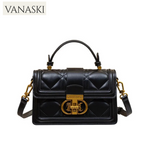 Black quilted handbag with gold accents on a white background, featuring the Vanaski brand.
