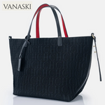 Black handbag with red and white accents on a light gray background, featuring the Vanaski brand.