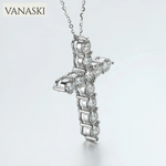 Silver cross pendant with clear stones on a white background, branded 'VANASKI'.