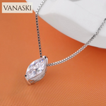 Silver necklace with a clear pendant on an orange background, featuring the Vanaski brand.