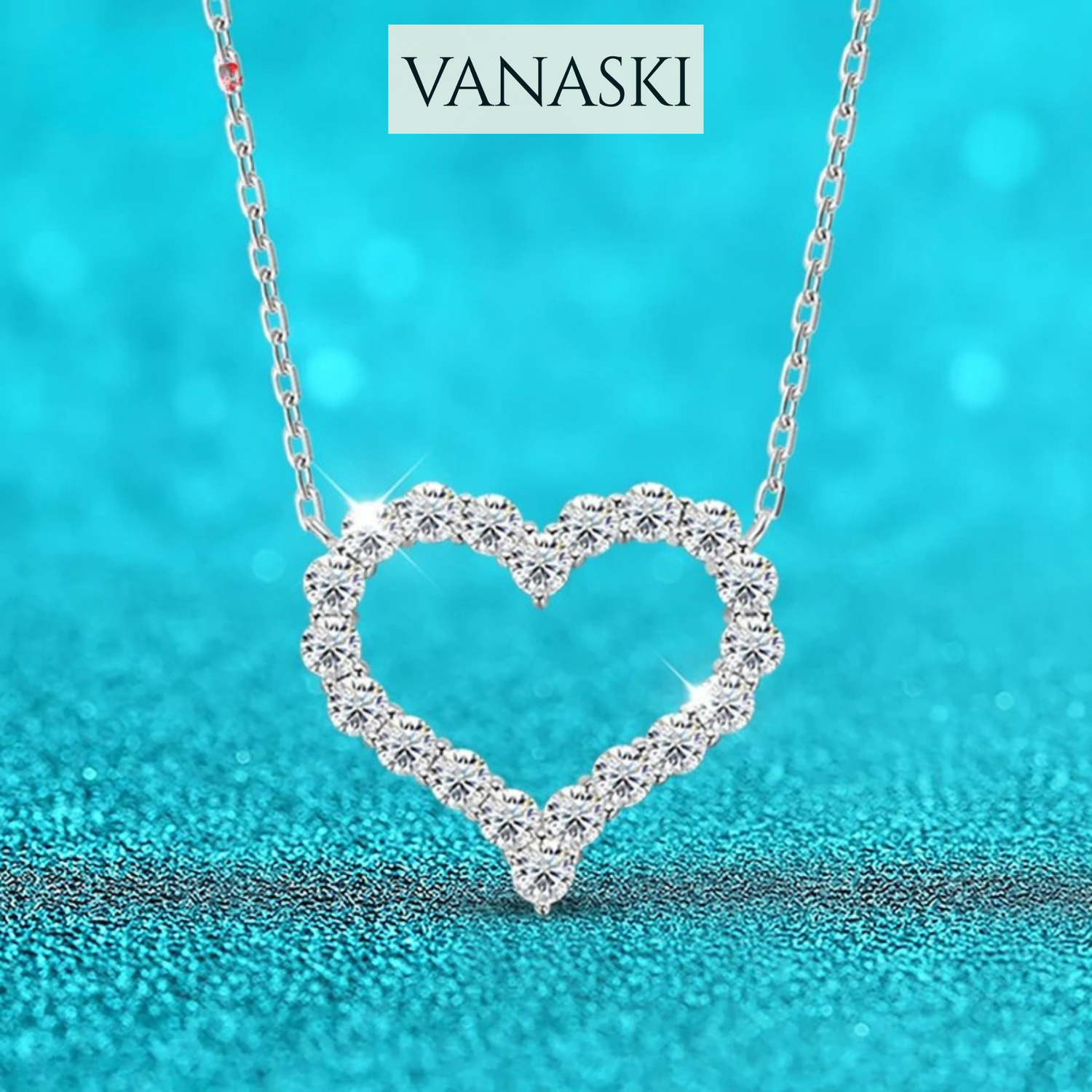 Heart-shaped diamond necklace on a blue background with 'VANASKI' branding.
