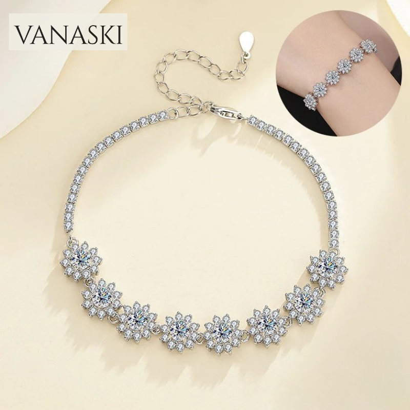 Silver necklace with floral design on a beige background, featuring the Vanaski brand.