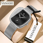 Silver watch with black face on a beige surface, featuring the VANASKI brand.