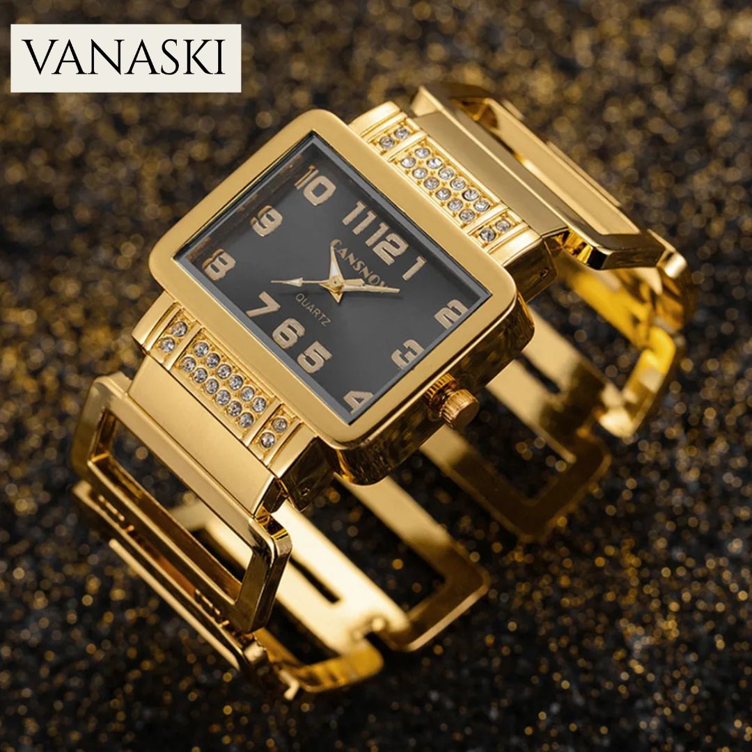 Gold wristwatch with black face on a glittery background, featuring the Vanaski brand.