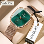 Vanaski watch with green face and rose gold mesh band on a beige surface