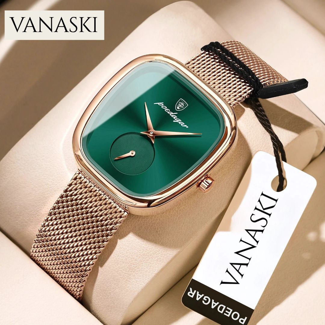 Vanaski watch with green face and rose gold mesh band on a beige surface
