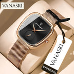 Gold watch with black face on a beige surface, featuring the Vanaski brand.