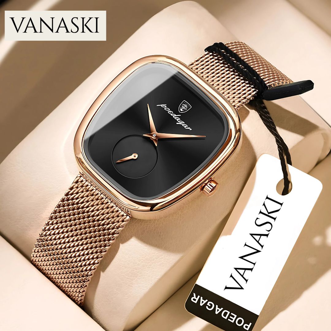 Gold watch with black face on a beige surface, featuring the Vanaski brand.
