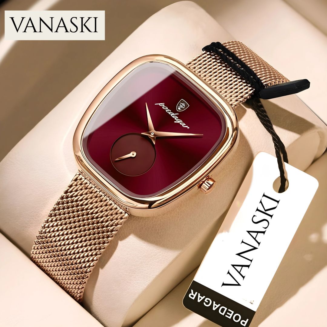 Gold watch with red face and mesh band on a beige surface, featuring the Vanaski brand.