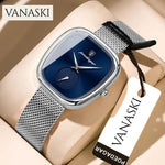 Vanaski watch with blue face and silver mesh strap on beige surface