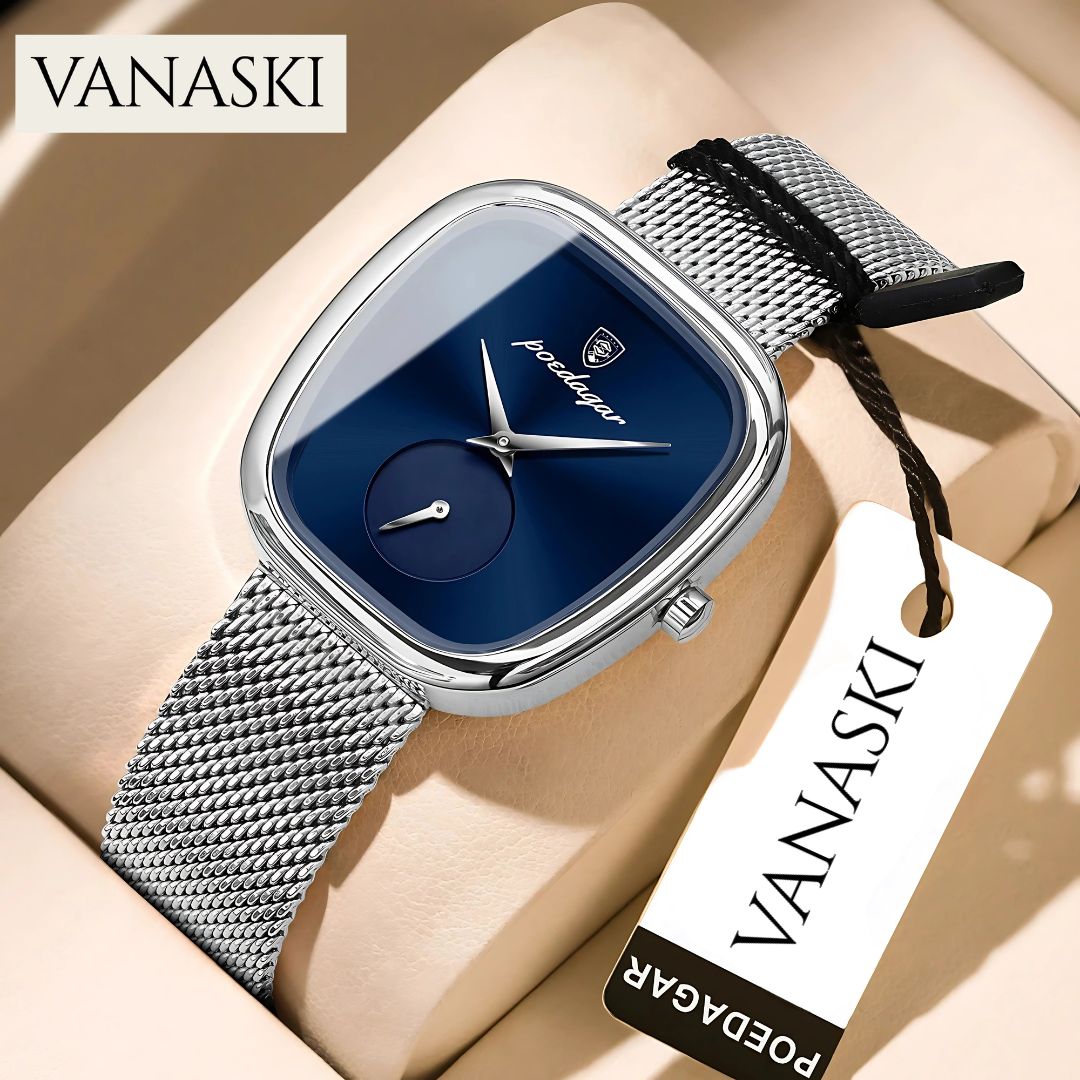 Vanaski watch with blue face and silver mesh strap on beige surface