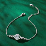 Silver bracelet with a diamond on a green background