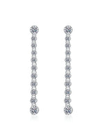 Pair of silver earrings with clear stones on a white background