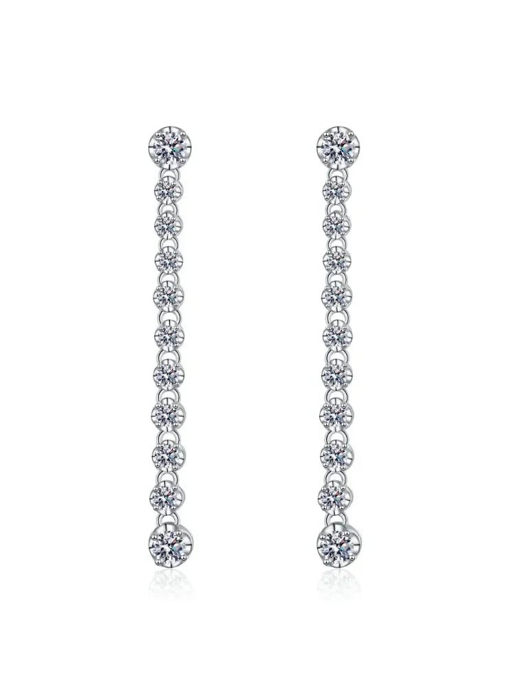 Pair of silver earrings with clear stones on a white background