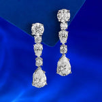 Diamond earrings on a blue satin background