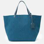 Blue tote bag with a monogram pattern on a white background