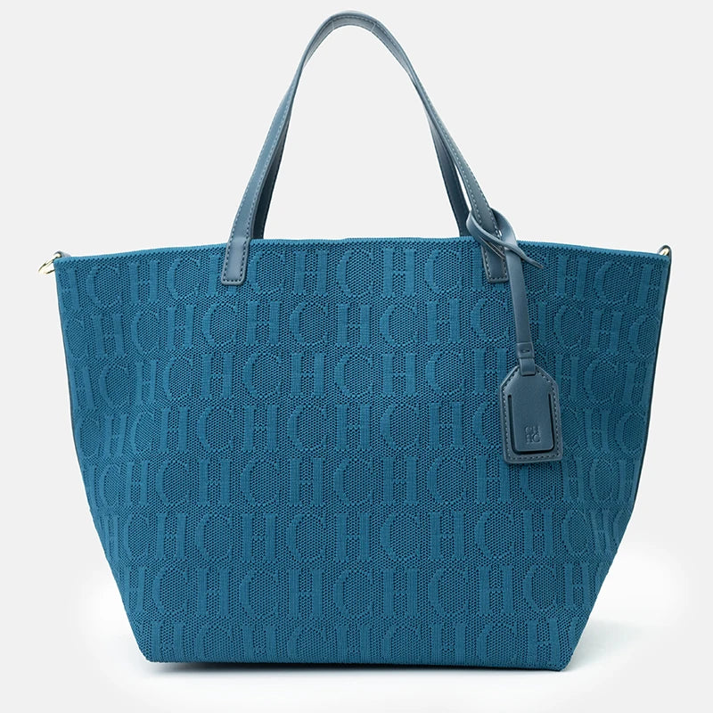 Blue tote bag with a monogram pattern on a white background
