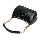 Black handbag with gold chain strap on a white background
