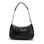 Black handbag with chain strap on a white background